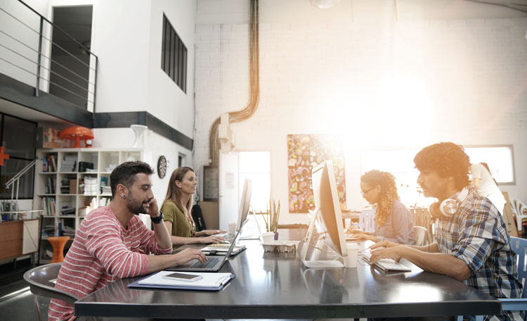 man and working at desks in modern casual office