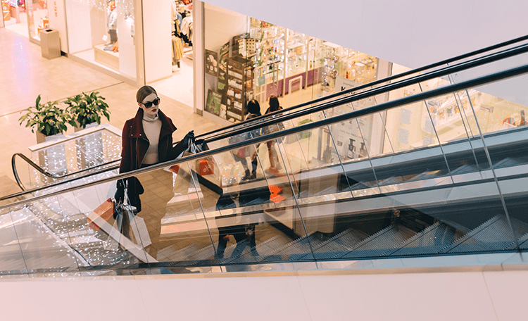 shoppers on an escalator