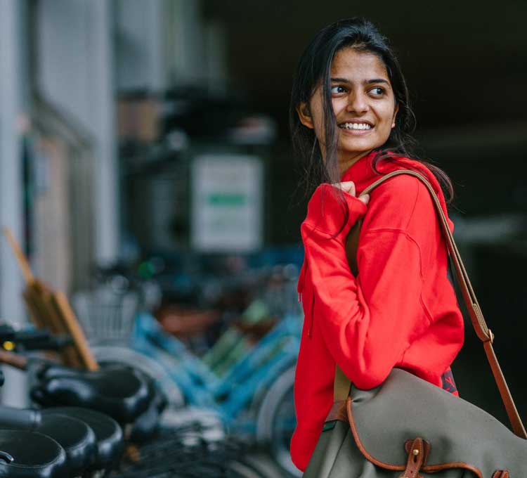 woman with backpack by bikes
