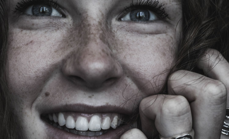 black & white young woman eyes raised, smiling