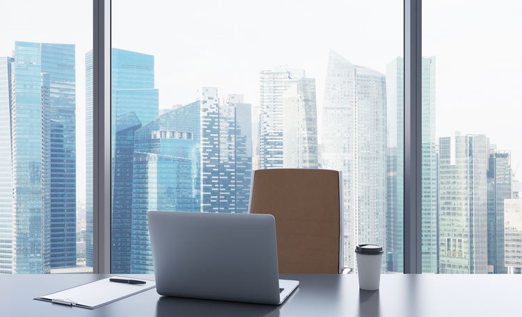 desk by window of skyscraper